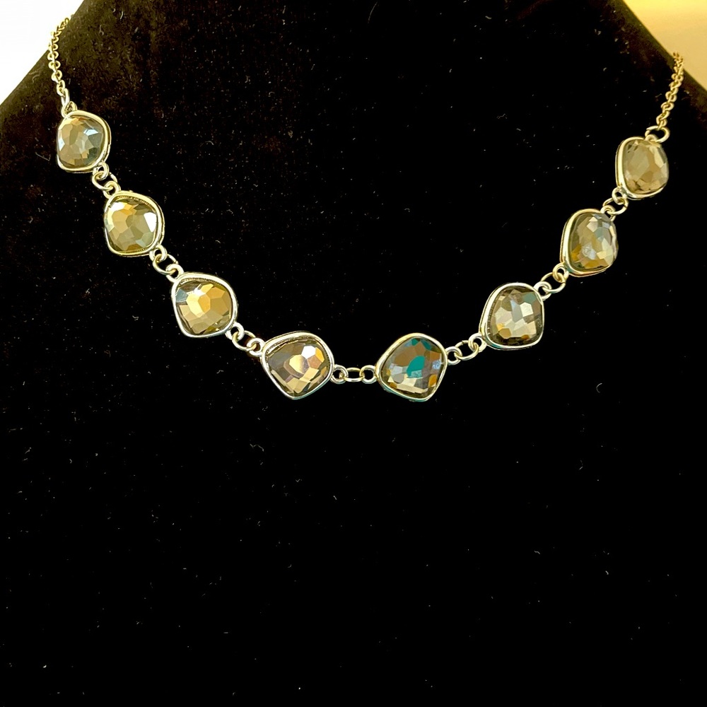 Silver necklace with row of multi faceted grey crystals
